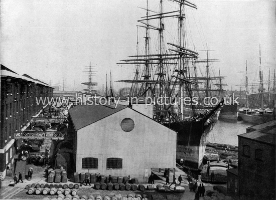 The London Docks, with goods on Quays Side, London. c.1890's.